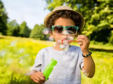 young child blowing bubbles