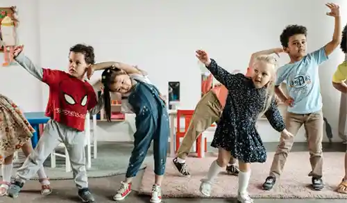 Children in a classroom stretching