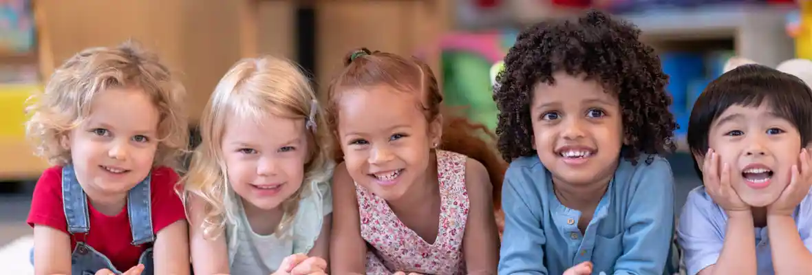 Preschool children laying on a rug