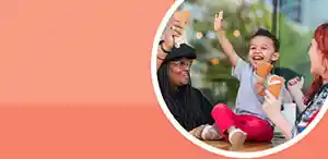 Preschool child eating ice cream with two women
