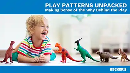 Preschool child playing with dinosaur figures on floor